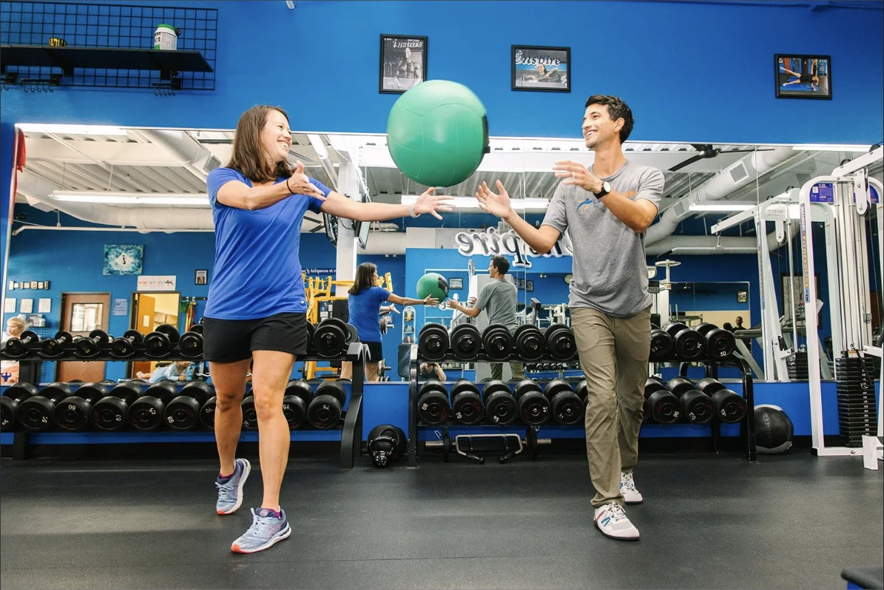 Dr. Sam Gallardo running a patient through a reactive medicine-ball drill at On The Run Physical Therapy