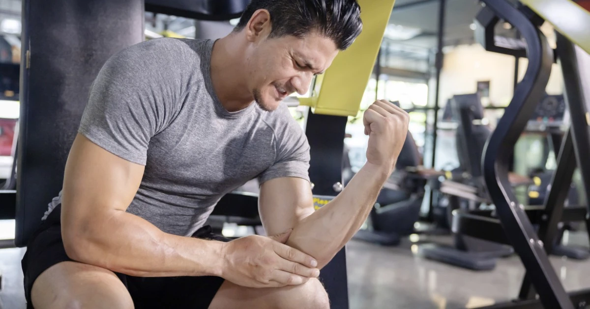 Physical therapist assessing a patient's elbow, wrist, and hand mobility