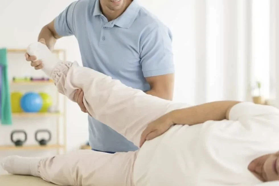 Physical therapist assessing a patient's knee movement and alignment