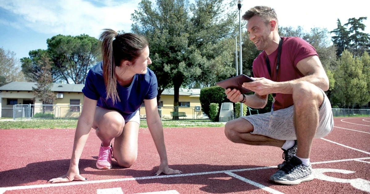 Doctor of Physical Therapy reviewing a runner's training plan
